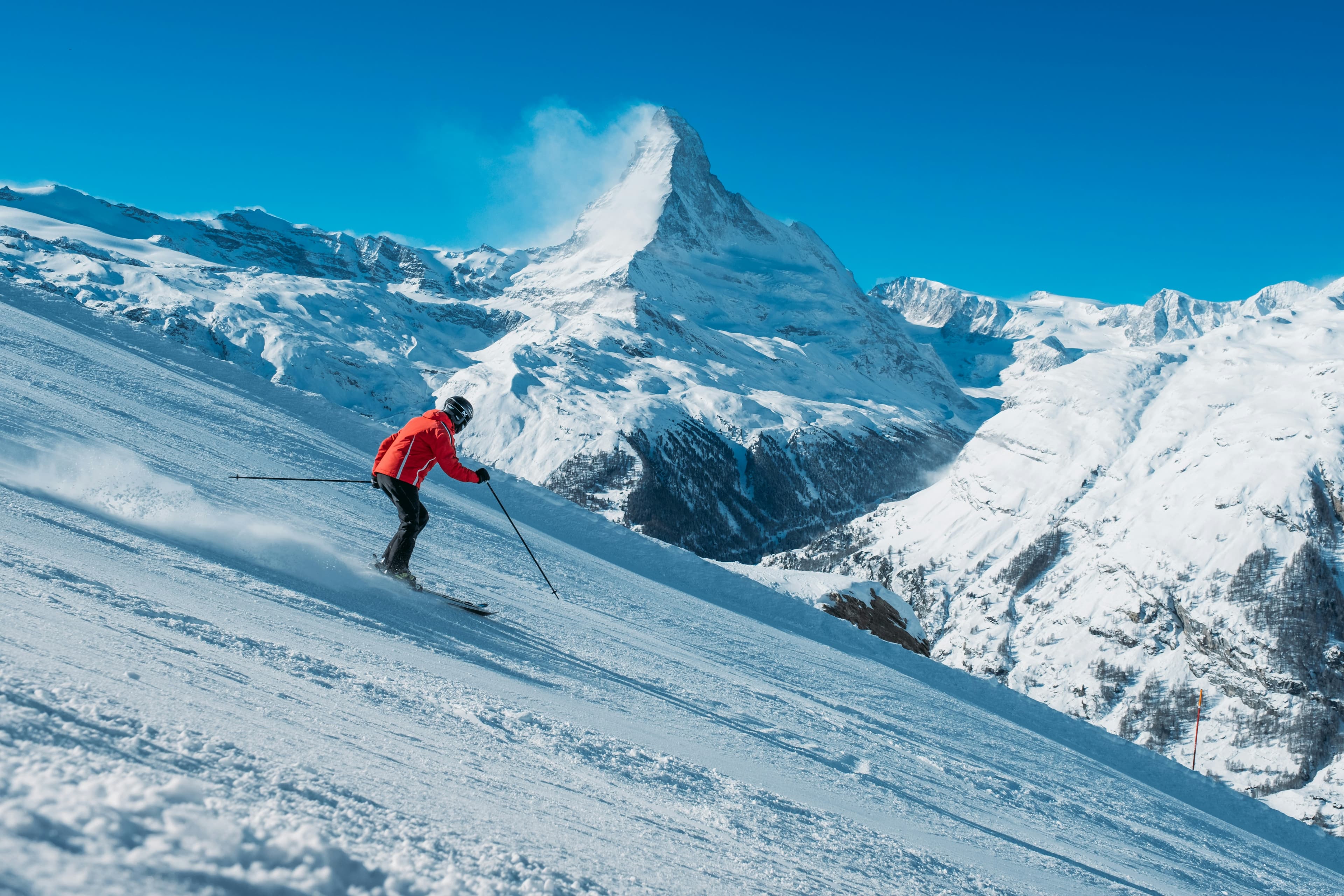 Skier descending a mountain slope