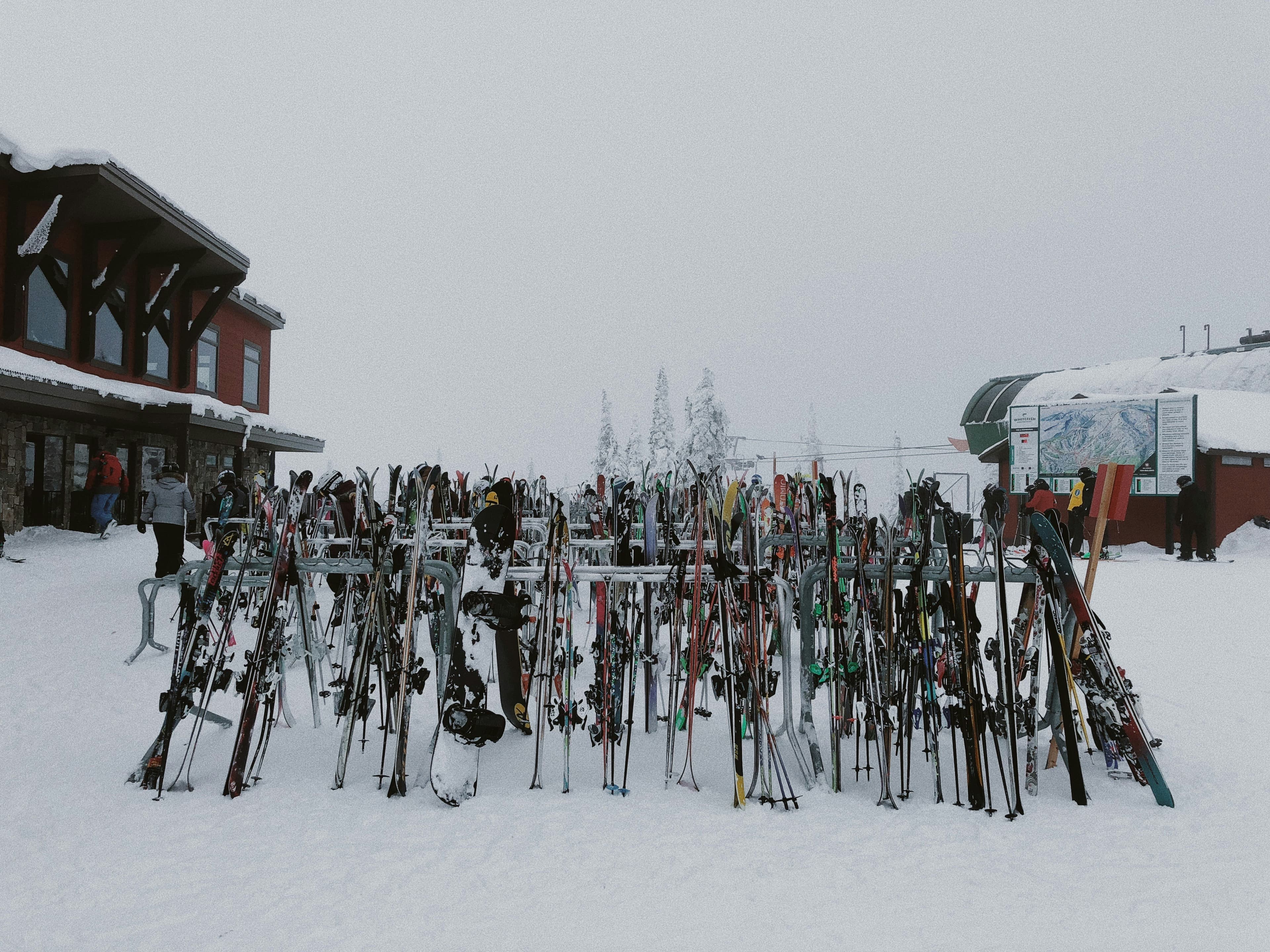 Skiers queuing at a lift with mountains in the background